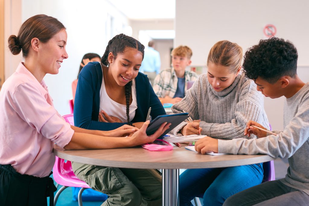 Teacher supporting learning with digital resources